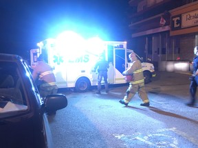 Emergency crews tend to a wounded man after a shooting at the Town & Country Motel in Calgary on July 28, 2018.