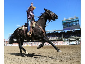 Hailey Kinsel from Cotulla, Texas, waves to the crowd after she was the fastest on the day in ladies barrel racing at the Calgary Stampede rodeo, Thursday July 12, 2018. Gavin Young/Postmedia