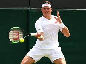 Milos Raonic returns against John Millman of Australia during their Men's Singles second round match on day three of the Wimbledon Lawn Tennis Championships at All England Lawn Tennis and Croquet Club on July 4, 2018 in London, England. (Matthew Stockman/Getty Images)