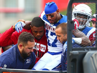 The Montreal Alouettes' Joe Burnett is taken off the field with an injury during CFL action against the Calgary Stampeders at McMahon Stadium in Calgary on Saturday July 21, 2018.
