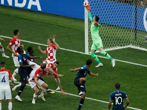 Croatia's forward Mario Mandzukic (C) heads the ball and scores an own goal after France's forward Antoine Griezmann (unseen) shot a free kick during the Russia 2018 World Cup final at the Luzhniki Stadium in Moscow on July 15, 2018. Adrian Dennis/Getty Images