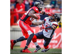 Calgary Stampeders ball-carrier DaVaris Daniels gives Ottawa Redblacks defender Josh Johnson the ol’ stiff-arm  during CFL football action at McMahon Stadium in Calgary during this June 28 game. Photo by Al Charest/Postmedia file