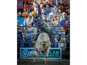 Texas bull rider Koal Livingston rides 2Trouble during the second night of the PBR Ranchman's Bullbustin event in Calgary on Wednesday, July 4, 2018. Al Charest/Postmedia