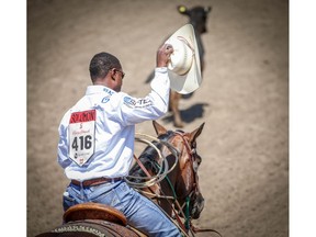 Texas cowboy Cory Solomon celebrates after posting a time (6.9 seconds) on Day 1 of the tie-down roping event during the 2018 Calgary Stampede on Friday, July 6, 2018. Al Charest/Postmedia