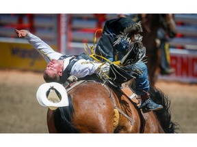 Jake Vold of Airdrie, Alberta rides Welcome Delivery to a score of 88 in Day 3 of the Bareback Riding event during the 2018 Calgary Stampede on Sunday, July 8, 2018. Al Charest/Postmedia
