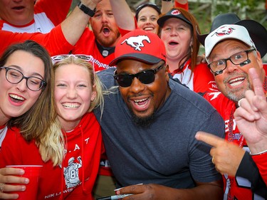 Nik Lewis poses for a photo with Nik Lewis Nation fans during a tailgate party before a game between the Calgary Stampeders and the Montreal Alouettes,the CFL receptions leader signed a one-day contract with Stampeders before announcing his retirement last Friday.