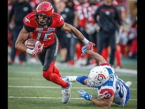 Calgary Stampeders Eric Rogers makes a catch in front of Greg Ducre Montreal Alouettes during CFL football in Calgary on Saturday, July 21, 2018.