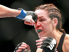 Alexis Davis takes a blow to the face as she fights Katlyn Chookagian  during UFC Fight Night at the Saddledome in Calgary on Saturday, July 28, 2018 in a preliminary match. Chookagian won by unanimous decision. (Jim Wells/Postmedia Network)