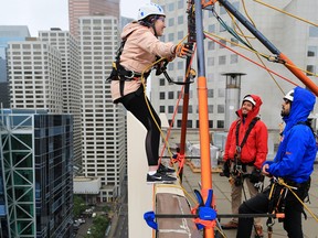 Postmedia reporter Anna Junker tries the Make-A-Wish Rope for Hope rappel on the Barclay Building in downtown Calgary on Tuesday July 3, 2018. Gavin Young/Postmedia  
Gavin Young