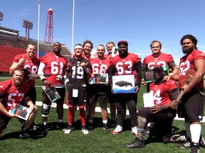 Stampeders QB Bo Levi Mitchell surprised his offensive line teammates with gifts before practice on Monday July 16, 2018. Dean Pilling/Postmedia