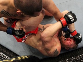 Cain Velasquez connects on a left to the face of Brock Lesnar in the first round during the heavyweight title bout during UFC 121 on October 23, 2010 in Anaheim, California.