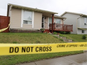 Police tape surrounds a home in the 1300 block of Falconridge Drive N.E. in Calgary after an early morning serious assault on July 2, 2018. One person was left in life threatening condition. Gavin Young/Postmedia