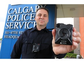 Calgary Police Service Staff Sgt. Travis Baker wears and holds the service's new Axon body camera on Tuesday July 3, 2018.  Gavin Young/Postmedia