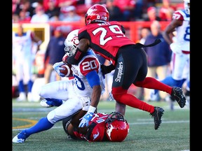 The Calgary Stampeders Jamar Wall helps tackle the Montreal Alouettes' Tyrell Sutton during CFL action at McMahon Stadium in Calgary on Saturday July 21, 2018. Calgary won the game 25-8