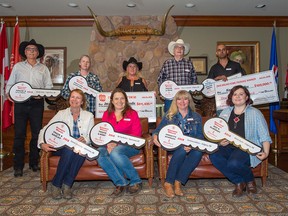 Stampede Lotteries prize winners pose for a group photo after they were presented with their prizes on Tuesday July 24, 2018.  Gavin Young/Postmedia