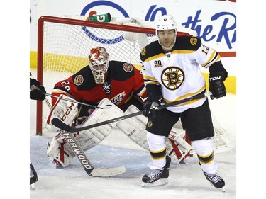 Boston Bruins Jarome Iginla waits for a tip on Calgary Flames goalie Reto Berra in third period NHL action at the Scotiabank Saddledome in Calgary on Tuesday December 10, 2013. Darren Makowichuk/Calgary Sun/QMI Agency