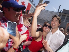 Prime Minister Justin Trudeau takes a selfie with a young woman during Canada Day festivities in Leamington Ont. Sunday, July 1, 2018.