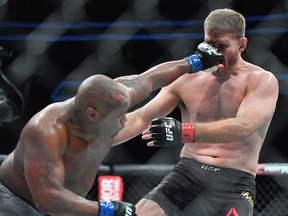 Daniel Cormier (left) punches Stipe Miocic during their heavyweight championship fight at T-Mobile Arena on July 7, 2018 in Las Vegas. (Sam Wasson/Getty Images)