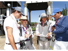 Stewards Sue Hawse (CAN) and Monica Gomez (MEX) join riders behind the clock tower as they prepare to ride at the Spruce Meadows North American in Calgary, AB on Thursday, July 5, 2018. Jim Wells/Postmedia