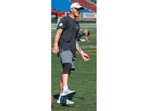 Calgary Stampeder QB Bo Levi Mitchell exaggerates as he walks in practice in Calgary on Friday, July 13, 2018 wearing a sleeve on his right knee. Mitchell took an awkward hit on the same knee on Thursday night against Ottawa and didn't participate in the team run down. Jim Wells/Postmedia