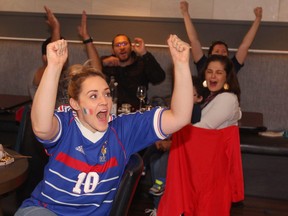 Rachel Paulson (L) joins other French fans celebrate a win in the World Cup final over Croatia as they gather at Breizh Bistro on 17 Ave SW in Calgary on  Sunday, July 15, 2018.   Jim Wells/Postmedia