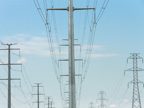 Power transmission lines are shown on the eastern edge of Calgary on Wednesday, July 18, 2018.  Calgarians are using more AC power in the summer for items like air conditioning and fans. Jim Wells/Postmedia