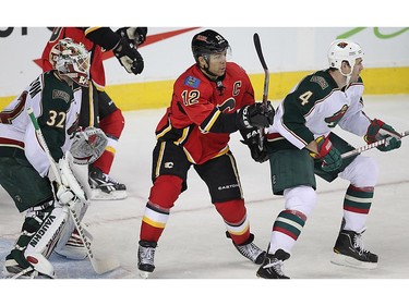 Calgary Flames Jarome Iginla between Niklas Backstrom and Clayton Stoner of the Minnesota Wild during NHL hockey  in Calgary, Alberta, Saturday January 7, 2012. AL CHAREST/CALGARY SUN/QMI AGENCY