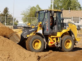 Police say a front end loader (not the one pictured) was reported stolen from a worksite in the area of 61st Street and 100 Avenue S.E. on Monday. It was spotted two days later and the thief was chased down by contractors from a nearby construction site.