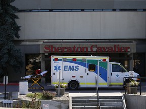 An ambulance sits outside the Sheraton Caviler Hotel in northeast Calgary after a drowning scare. Photo by Al Charest, Postmedia Network