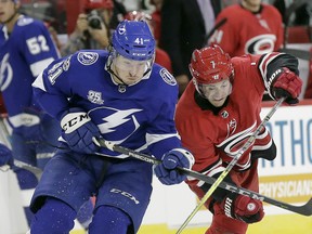 Tampa Bay Lightning's Boris Katchouk (41) and Carolina Hurricanes' Derek Ryan (7) skate for the puck during the second period of an NHL exhibition hockey game in Raleigh, N.C., Wednesday, Sept. 20, 2017. (AP Photo/Gerry Broome) ORG XMIT: NCGB105