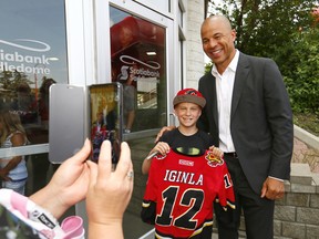 NHL great Jarome Iginla signs autographs for fans L-R, Mom, Lisa and son, Dean Smith,12, after he retired a Calgary Flame at the Scotiabank Saddledome in Calgary on Monday July 30, 2018. Darren Makowichuk/Postmedia