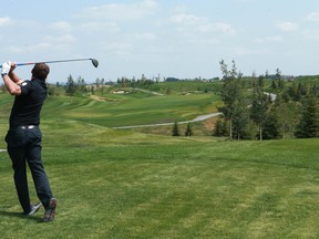 Mark Corrigan, Membership Account Executive hits a tee shot on hole #2 during a tour at Mickelson National Golf Club i the new community of Harmony west of Calgary on Tuesday, July 31, 2018. Jim Wells/Postmedia