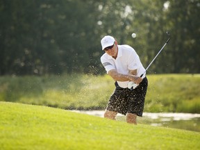Murray Fox gets out of the sand trap on the 15th hole of the Raven course during the Priddis Greens Charity Classic at the golf and country club on Tuesday, August 15, 2017 southwest of Calgary, Alta. The event raises money for the Prostate Cancer Centre. Britton Ledingham/Postmedia Network