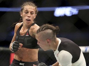 Joanna Jedrzejczyk, left, fights Jessica Andrade in a mixed martial arts bout at UFC 211 for the UFC women's strawweight championship, Saturday, May 13, 2017, in Dallas. (AP Photo/Gregory Payan)