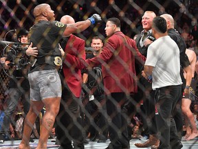 Daniel Cormier (L) challenges Brock Lesnar  (R) after winning his heavyweight championship fight against Stipe Miocic at T-Mobile Arena on July 7, 2018 in Las Vegas.