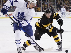 Boston Bruins' Austin Czarnik (27) battles Toronto Maple Leafs' Auston Matthews (34) for the puck during the first period of an NHL hockey game in Boston, Saturday, Dec. 10, 2016.