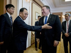 U.S. Secretary of State Mike Pompeo, second from right, greets Kim Yong Chol, second from left, North Korean senior ruling party official and former intelligence chief, as they arrive for a meeting at the Park Hwa Guest House in Pyongyang, North Korea, Friday, July 6, 2018.