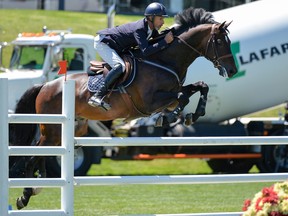 Richard Spooner rides to the win in the Lafarge Cavalry Charge on Sunday during the North American at Spruce Meadows.