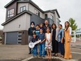 Karanbir Sidhu, centre, from Calgary stands with family in front of the 2018 Rotary Dream Home he won in the 2018 Calgary Stampede lotteries. Prize winners were presented with their prizes on Tuesday July 24, 2018. New this year Sidhu also won a cheque for $100,000. The dream home will soon be moved to the community of Walden. Gavin Young/Postmedia