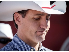 Prime Minister Justin Trudeau listens to speeches as he attends a pancake breakfast in Calgary on Saturday, July 7, 2018.