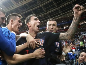 Croatia's Mario Mandzukic, center, celebrates after scoring his side's second goal during the semifinal match between Croatia and England at the 2018 soccer World Cup in the Luzhniki Stadium in Moscow, Russia, Wednesday, July 11, 2018.