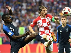 Croatia midfielder Luka Modric (centre) pursues the ball against France in the World Cup final on July 15.