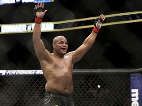 Daniel Cormier celebrates a win over Volkan Oezdemir in a light heavyweight championship mixed martial arts bout at UFC 220, Saturday, Jan. 20, 2018, in Boston.