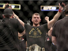 In this Jan. 21, 2018, file photo, Stipe Miocic gestures after a win over Francis Ngannou during a heavyweight championship mixed martial arts bout at UFC 220, in Boston.