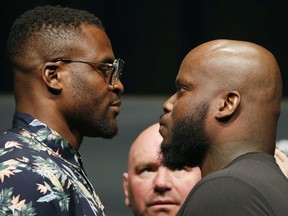 Francis Ngannou, left, and Derrick Lewis pose during a news conference for UFC 226, Thursday, July 5, 2018, in Las Vegas. The two are scheduled to fight in a heavyweight mixed martial arts bout Saturday in Las Vegas.