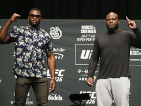 Francis Ngannou, left, and Derrick Lewis pose during a news conference for UFC 226, Thursday, July 5, 2018, in Las Vegas. The two are scheduled to fight in a heavyweight mixed martial arts bout Saturday in Las Vegas.