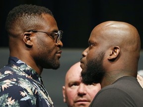 Francis Ngannou, left, and Derrick Lewis pose during a news conference for UFC 226, Thursday, July 5, 2018, in Las Vegas. The two are scheduled to fight in a heavyweight mixed martial arts bout Saturday in Las Vegas.