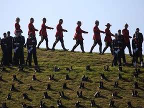 RCMP officers parade by the Canadian National Vimy Memorial in France during a centenary commemorative service on April 9, 2017.