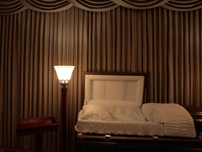 A light illuminates an empty casket in the funeral parlor of Greenwich Village Funeral Home on November 20, 2008 in New York City.