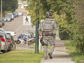 Calgary police surround an apartment in the 1700 block of 26th Ave S.W. on August 2, 2018 after a man broke into a residence and barricaded himself inside. CPS could be heard telling the man they knew he had a rifle inside. (Zach Laing / Postmedia Network)
